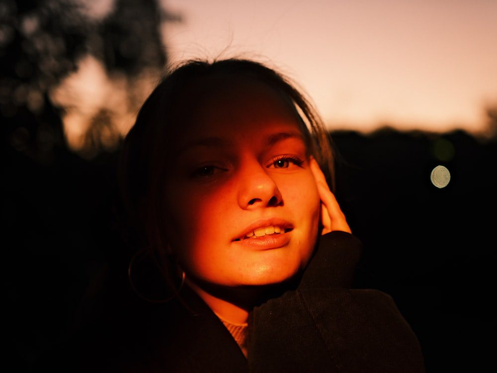 Person in warm backlight, a calm reflective moment representing emotional and neural change in therapy
