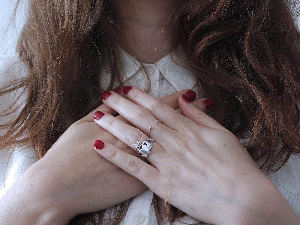 Person resting both hands over the heart, connecting with emotion in experiential therapy