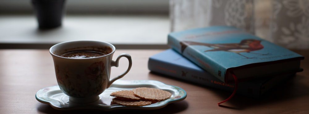 Coffee and a book on a table, slowing down and turning toward what you feel in AEDP