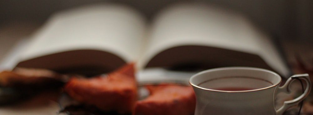Open book and a cup of coffee, a reflective rather than instructional psychodynamic approach