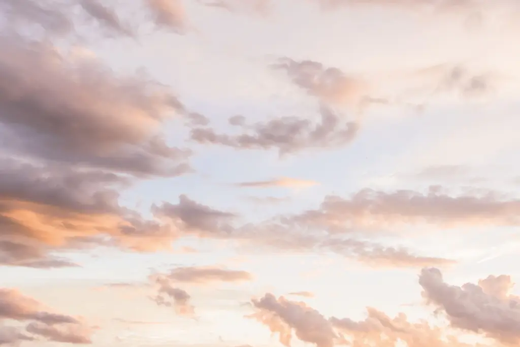 Soft pink and peach clouds at dusk