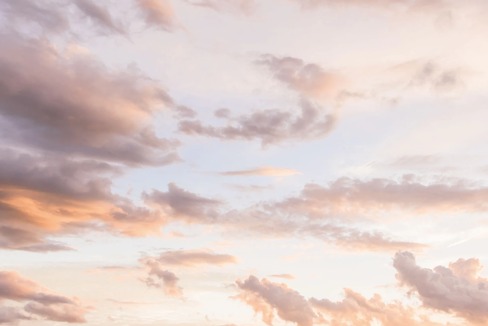Soft pink and peach clouds at dusk