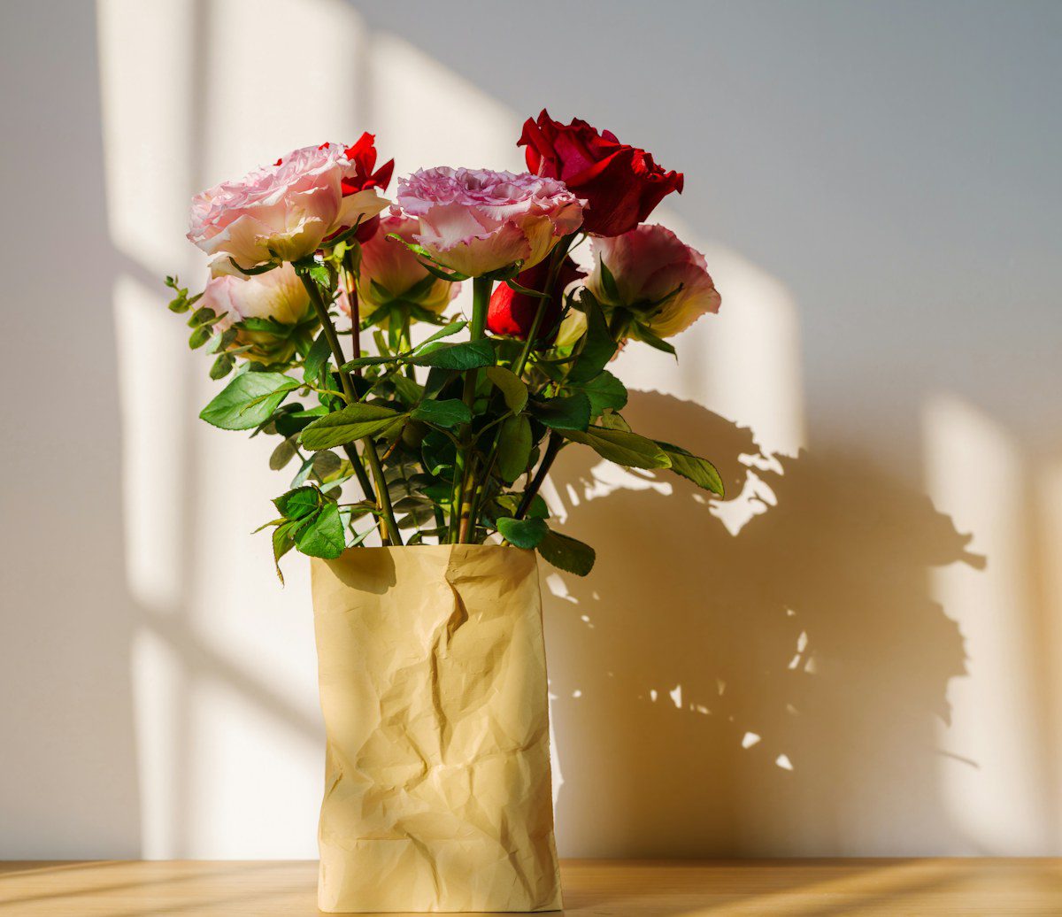Bouquet of roses wrapped in kraft paper in warm sunlight, representing AEDP emotion-focused therapy